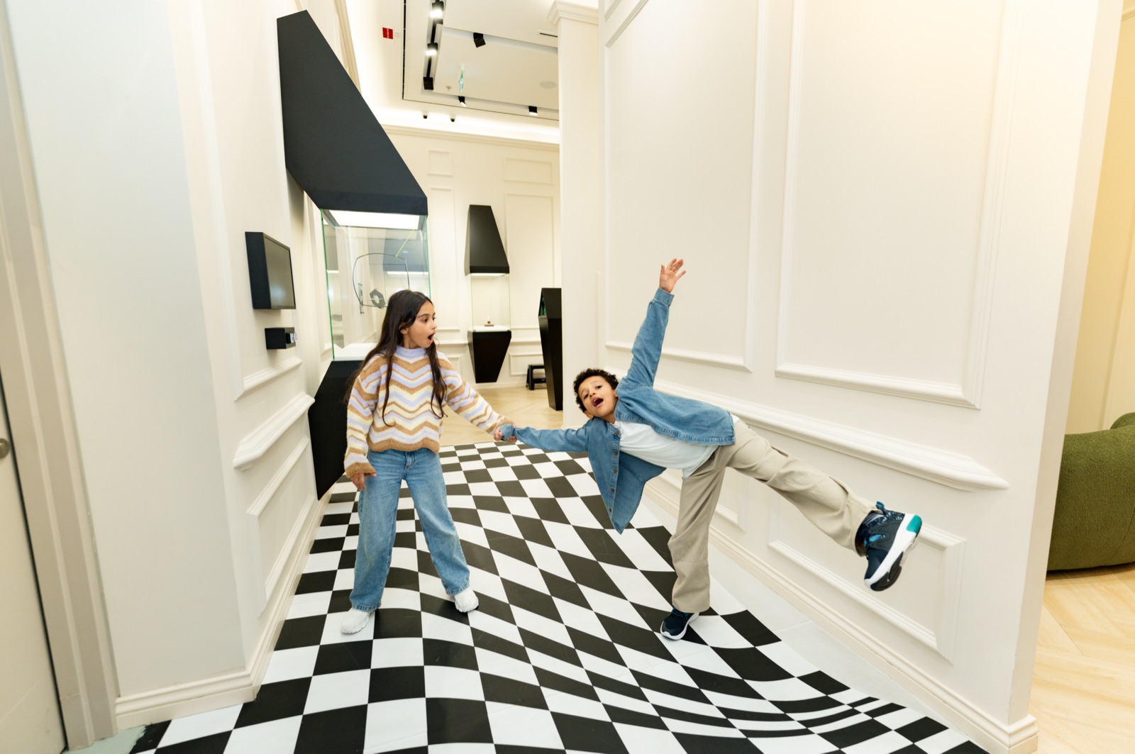 Family enjoying an interactive exhibit at illusion City Dubai